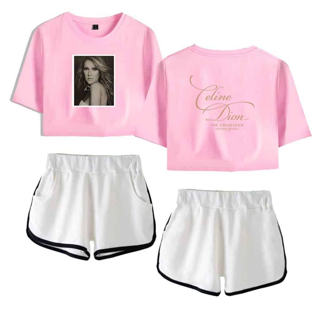 Pink cropped T-shirt with a black-and-white portrait of a woman on the front and cursive text reading "Celine Dion" on the back, paired with white athletic shorts with black trim.