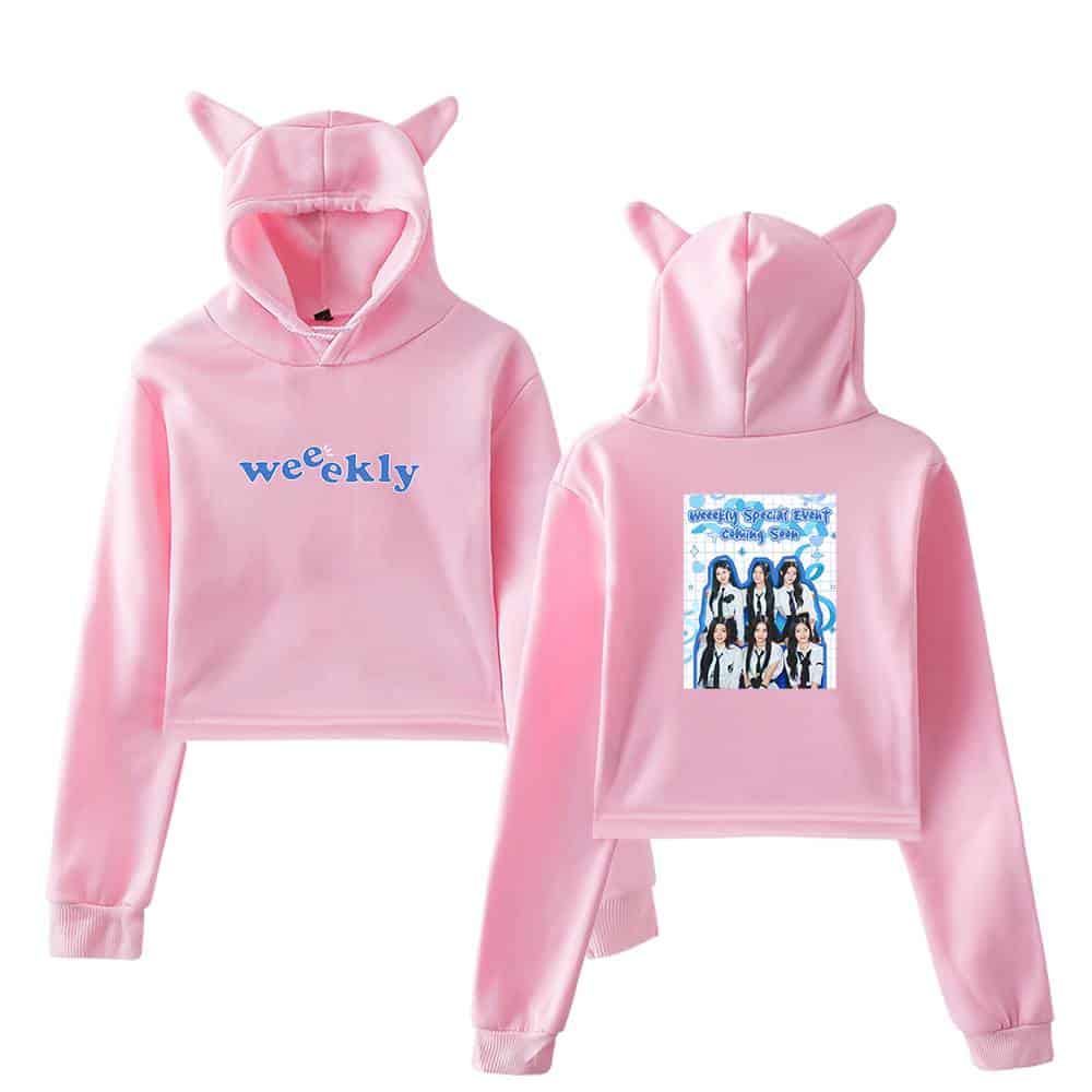 Wristbands and hoodies, pink hoodie with cat ears, "weekly" printed on front, image of the girl group on back, cute and trendy merchandise for fans and casual wear.