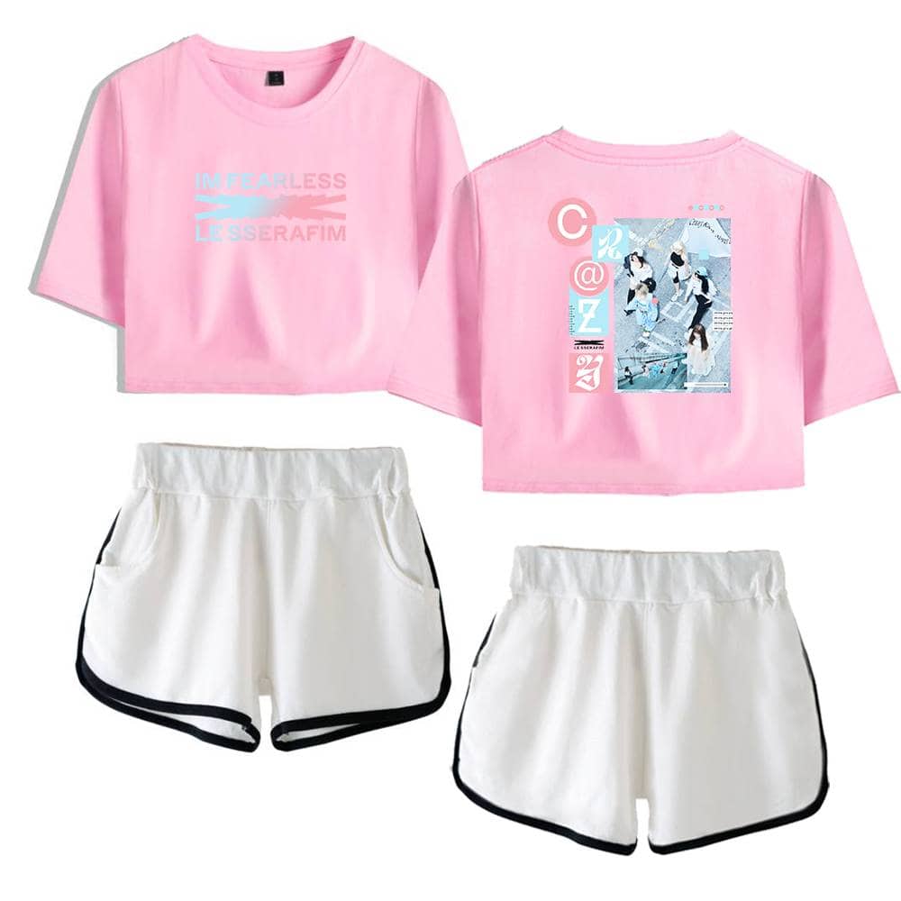 Pink cropped T-shirt with a graphic and slogan, paired with white athletic shorts featuring black trim, designed as casual sporty merchandise for women.