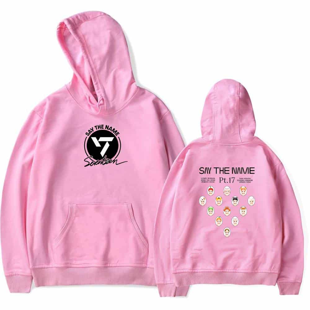 Pink hoodie featuring the phrase "Say the Name" with a stylized "V7" logo and "Seventeen" signature on the front; the back showcases "Say the Name Pt.17" along with various illustrated faces of the group members, perfect for fans.