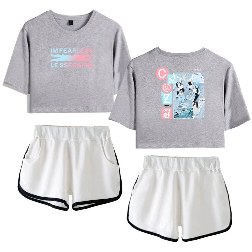 Comfy casual grey cropped T-shirt with pastel graphic text, sporty white shorts with black trim, and animated design with young women skateboarding and socializing on a sunny day, perfect for streetwear style, trendy fashion merchandise.