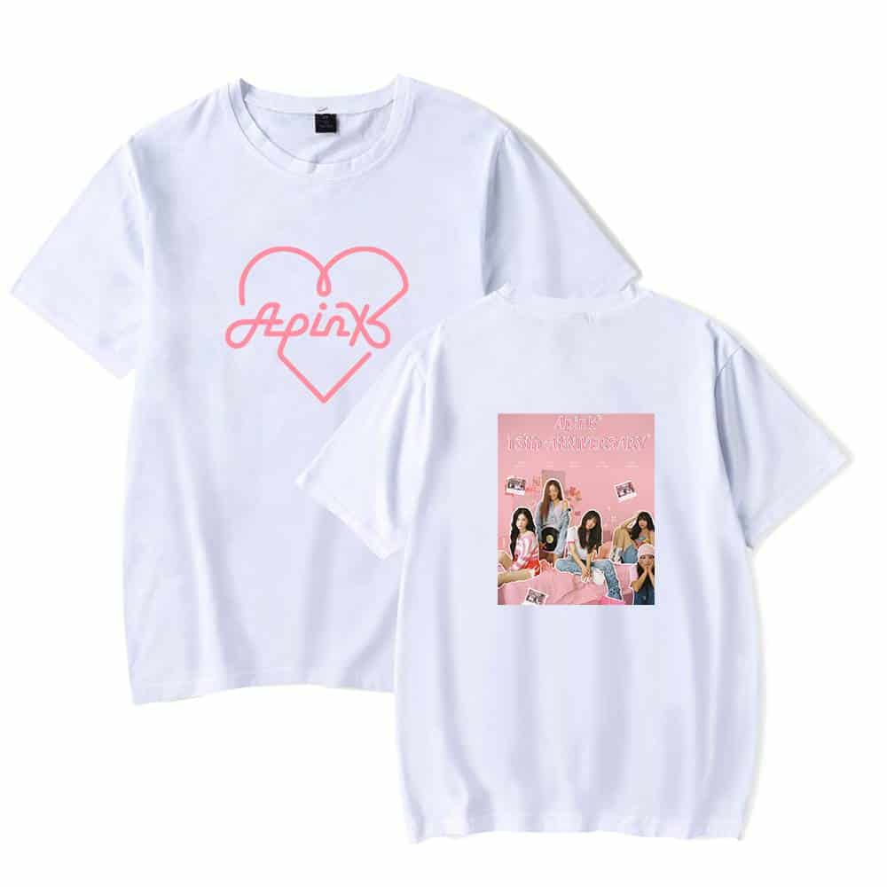 Pink neon "Apink" logo with heart design on front of white T-shirt. Back features a pink-themed group photo with members and text. Casual, stylish merchandise for fans of Apink.