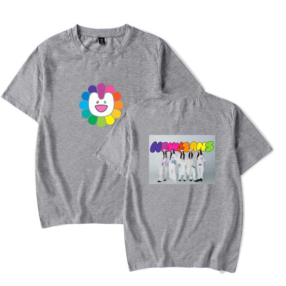 Colorful flower face logo on a gray T-shirt, featuring vibrant hues and playful design.