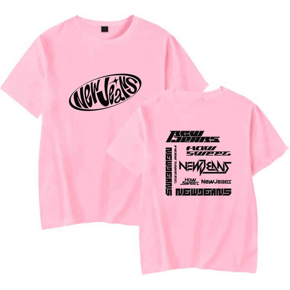 Pink graphic t-shirt with bold black text and logo designs, perfect for streetwear fashion.