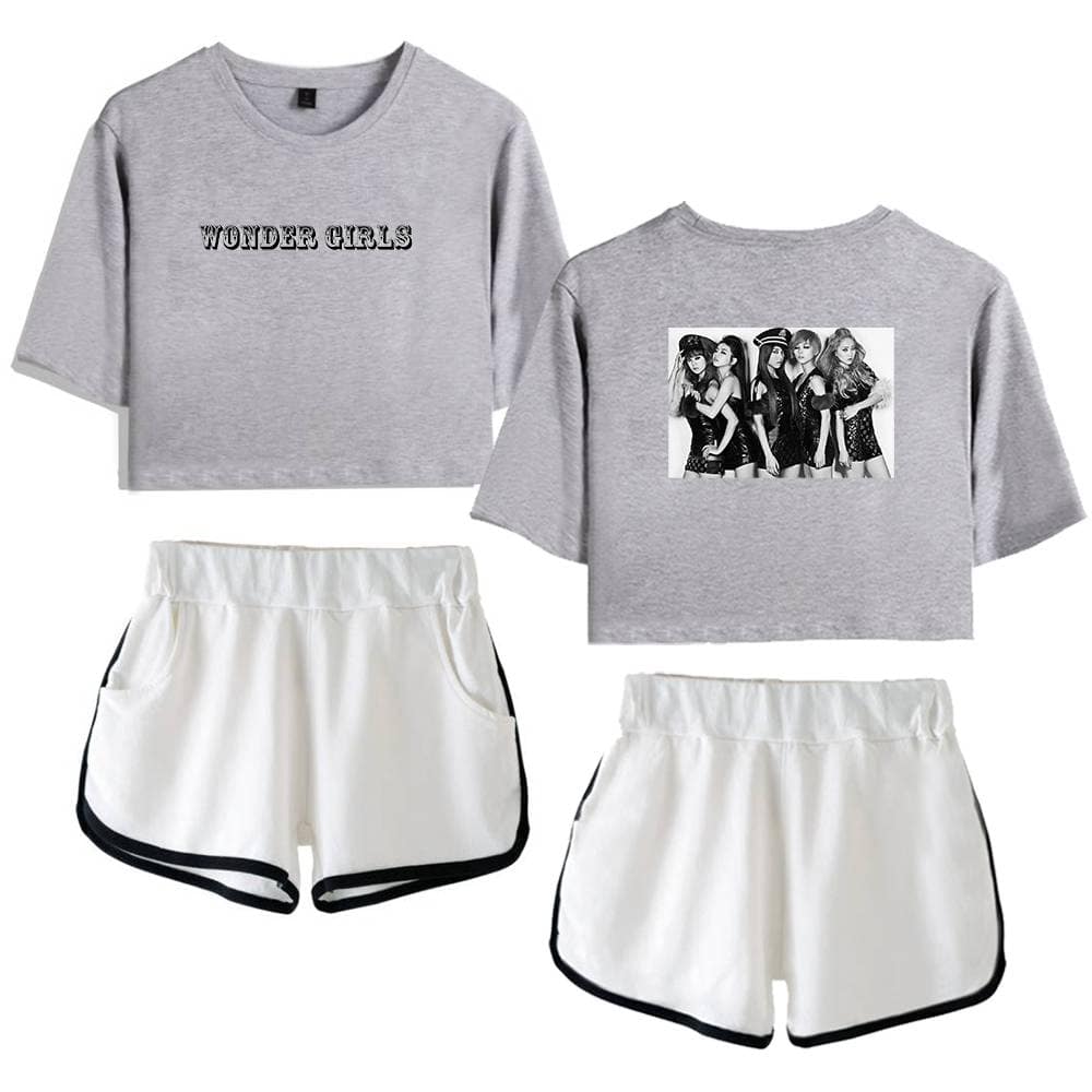Wonder Girls cropped sweatshirt with graphic and text, paired with white running shorts with black trim, ideal for casual or athletic wear.