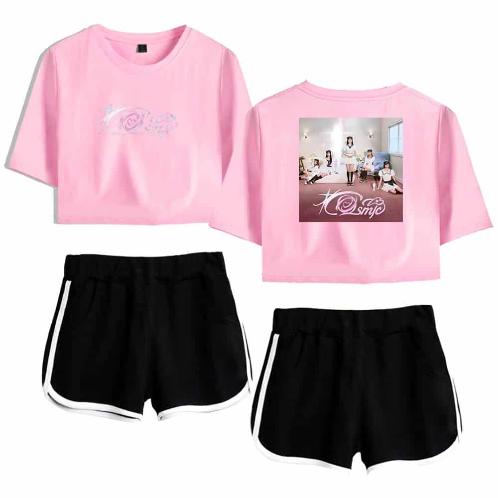 Pink crop top with graphic design featuring a heart and swirling pattern, paired with black athletic shorts with white trim, creating a trendy casual outfit inspired by the K-pop group TWICE.