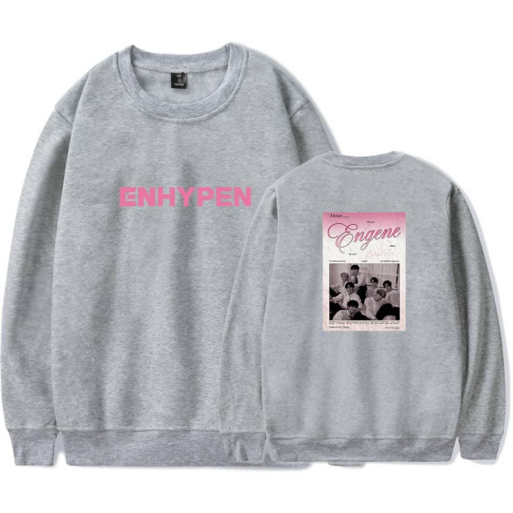 ENHYPEN sweatshirt with pink logo on the front and a graphic print on the back featuring a pink-themed design with group members and text. Perfect for fans of the K-pop group.