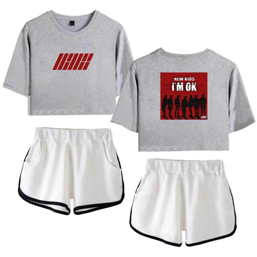 IHHH graphic on grey cropped sweatshirt and "New Kids I'm OK" on grey t-shirt paired with white athletic shorts with black trim. Casual, sporty merchandise for fans.
