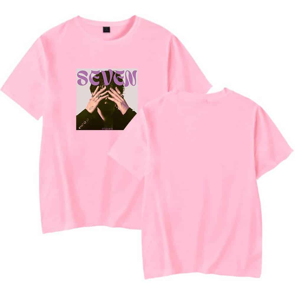 Seven pink graphic t-shirt with a photo of a person covering their face and purple "SEVEN" text on the front.