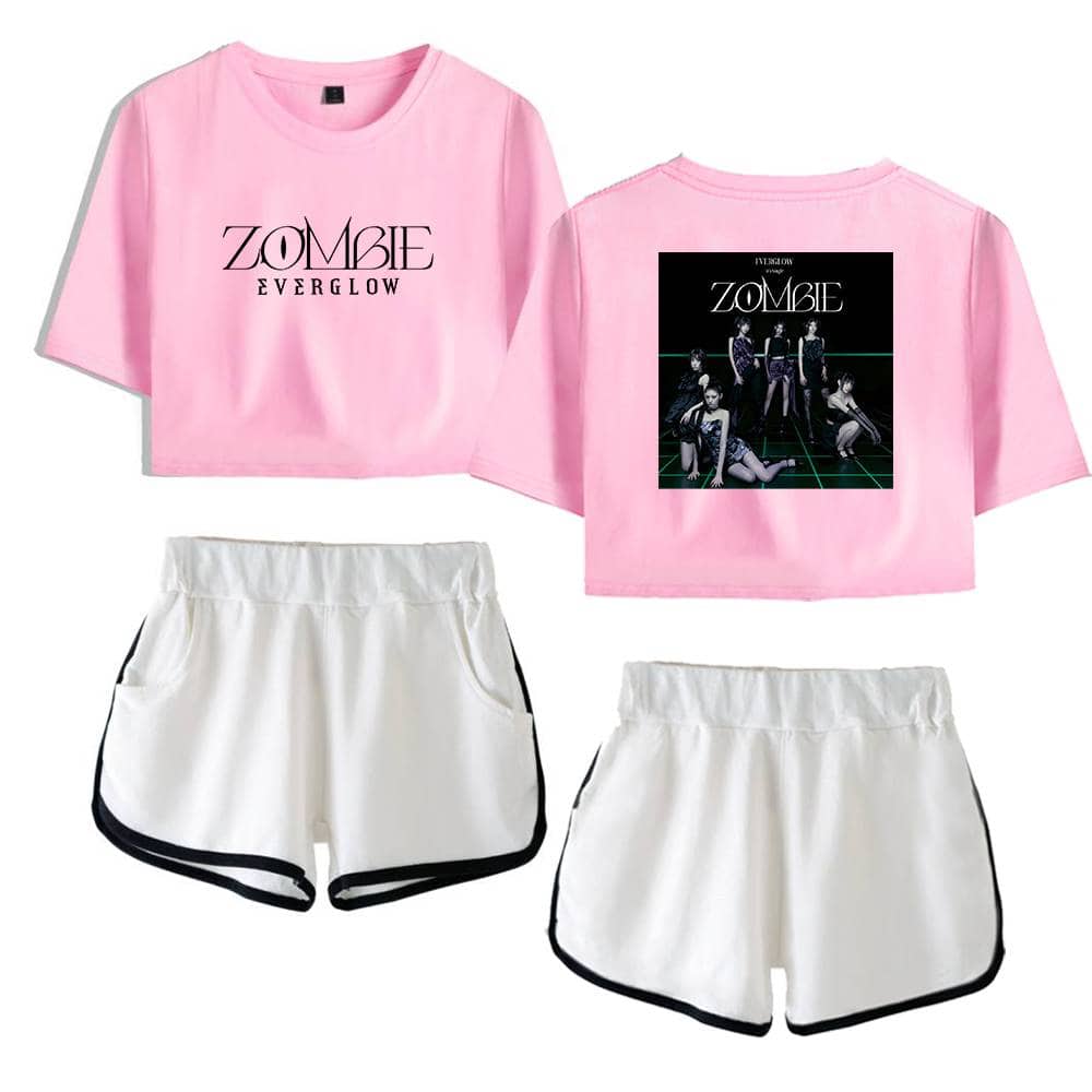 ZOMBIE Everglow pink cropped t-shirt with black and white graphic print, paired with white sporty shorts with black trim, trendy casual merch for fans.