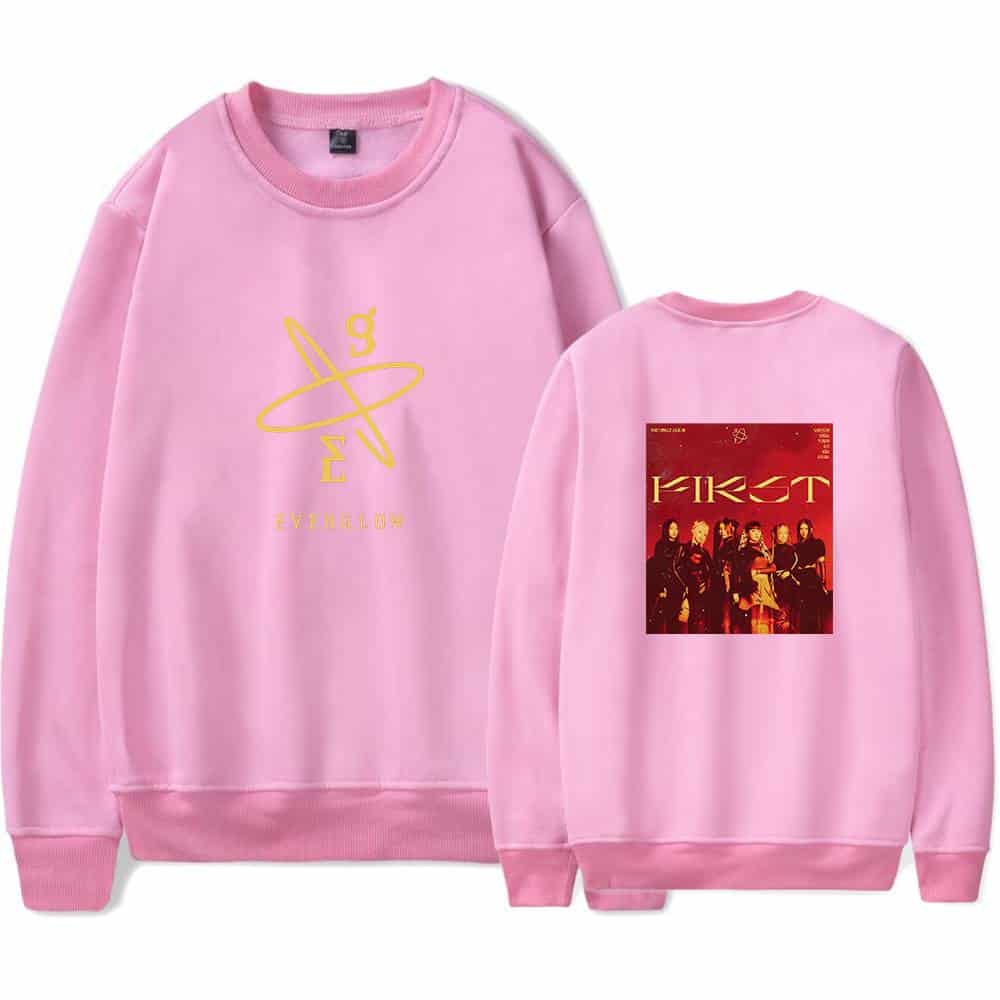 Hanger and pink sweatshirt with a yellow logo on the front and a graphic print of the girl group First on the back, made of soft material suitable for casual wear and merchandise collections.