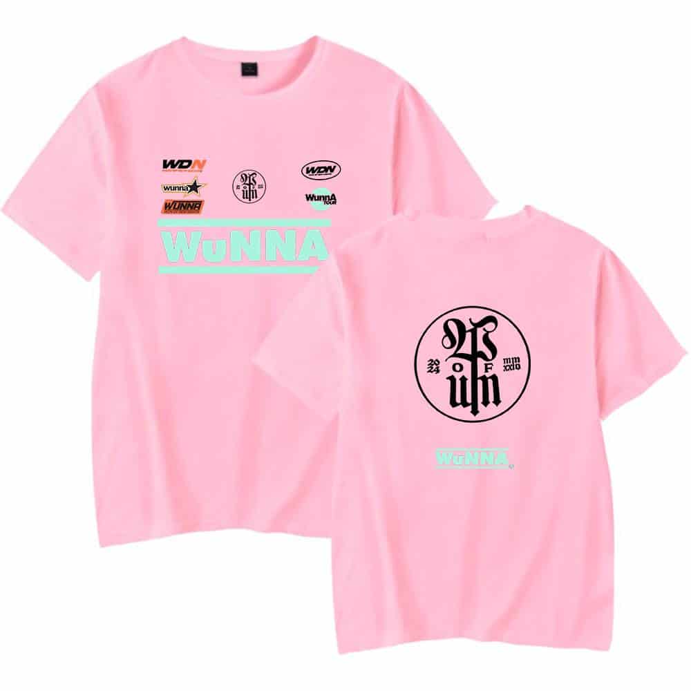 Pink oversized t-shirt with graphic print designs and "WuNNA" text in mint green, featuring various logo-inspired graphics on the front and back. Perfect streetwear merchandise for fans.