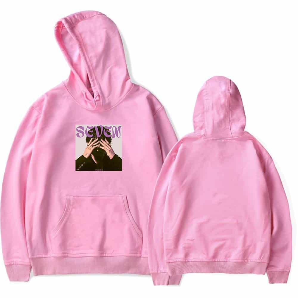 Seven hoodie with graphic print front and plain back in pastel pink, casual streetwear.