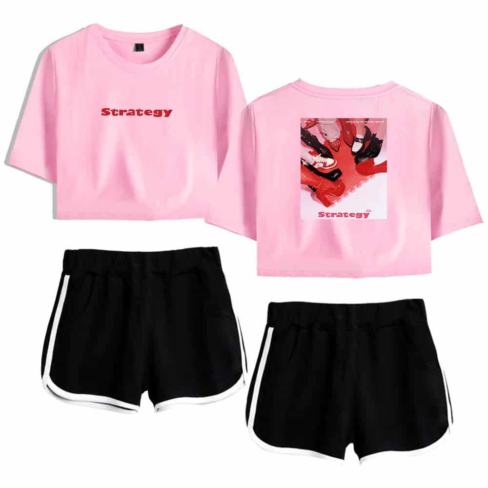 Pink cropped T-shirt with "Strategy" printed in red on the front and an image of shoes on the back, paired with black athletic shorts featuring white side stripes. Perfect for casual or sporty wear.
